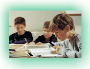 Boys sitting at a table reading