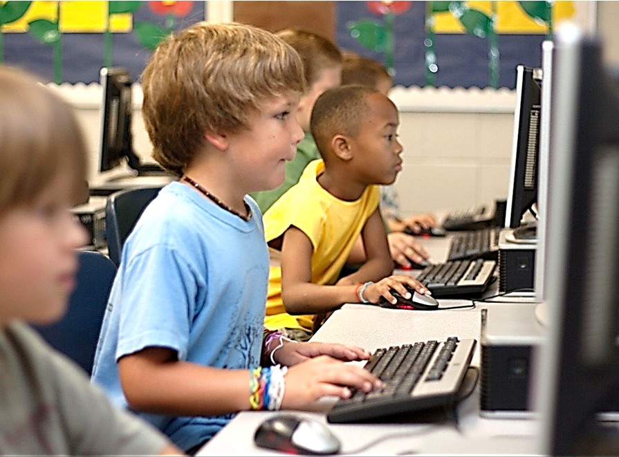 Three students using computers